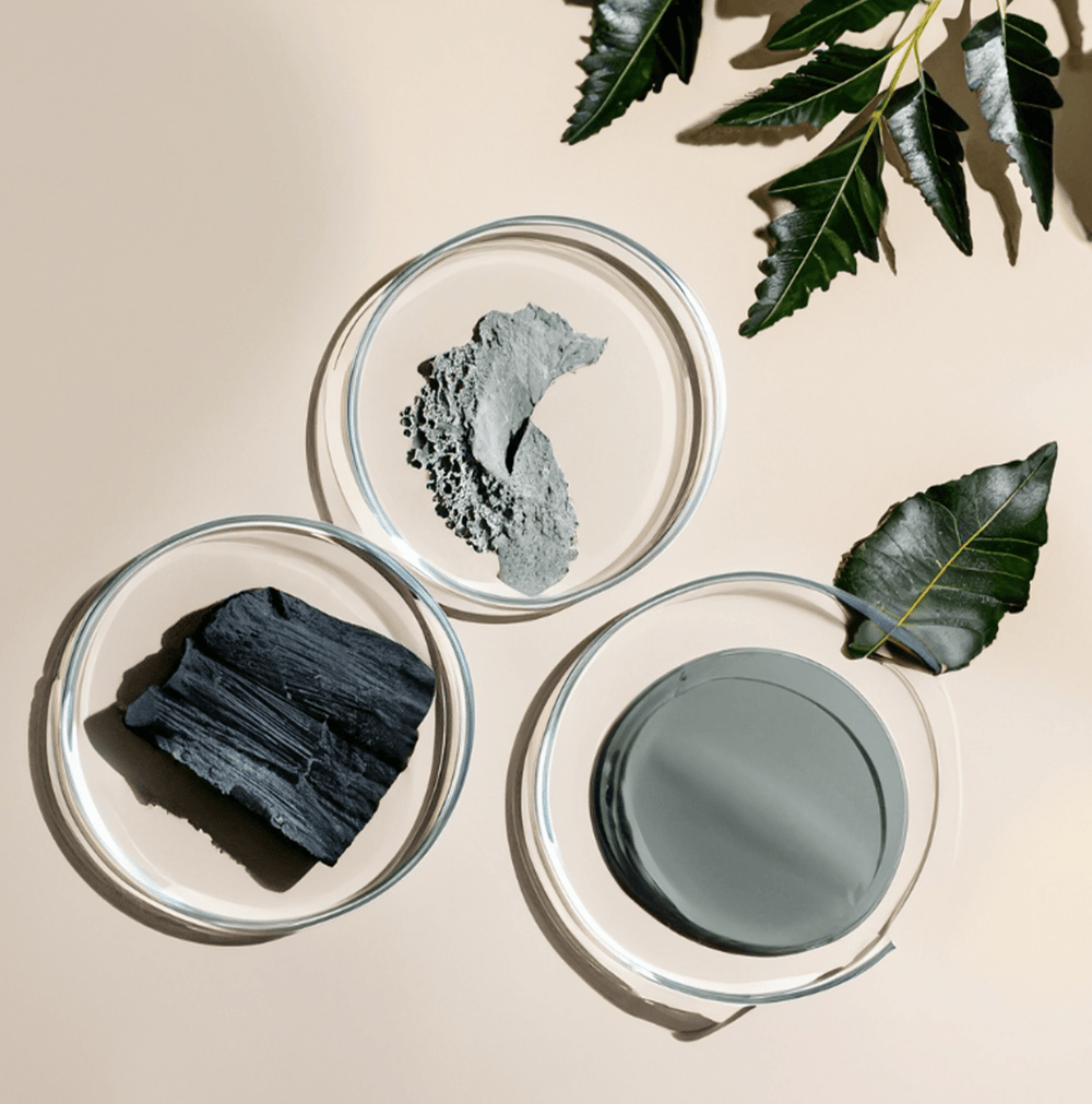Dermal Detox charcoal bath soak with Neem and Bentonite Clay to adsorb urban pollutants and clear acne bacteria.